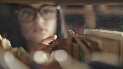 Woman searching for books in a library