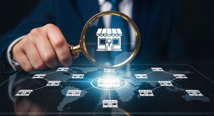 Businessman holding a magnifying glass over a digital map showing a network of franchise stores, symbolizing business expansion and global reach