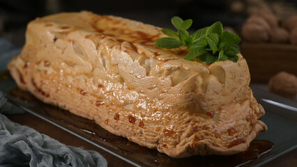 An elegant molotov dessert, featuring a perfectly caramelized meringue crust and a delicate mint garnish