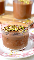 Indulgent chocolate mousse with pistachios and a spoon