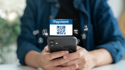 A person using a smartphone to scan a QR code for online payment, digital wallet, and fintech transactions, representing a modern cashless society and mobile banking.