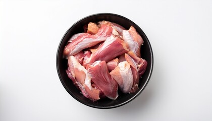 raw duck meat with skin pieces in black bowl n top view on white background