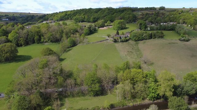 aerial view of the rochdale canal and a 646 road in the calder valley between mytholmroyd and Luddenden Foot surrounded by fields and trees