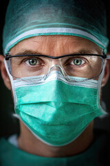 Close-up of a medical professional wearing protective gear and a mask.