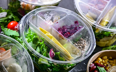 Round plastic boxes with pre-packaged vegetable salads