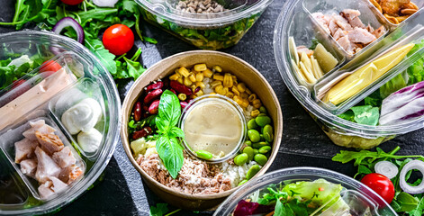 Round plastic boxes with pre-packaged vegetable salads