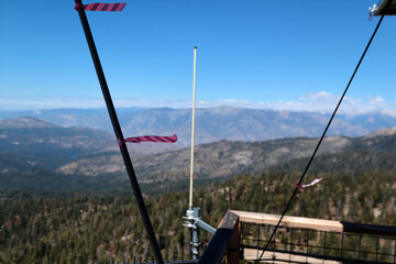 View of the mountain range from the observation tower. The railings of the tower are visible in the foreground, as well as the antennas