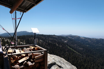 Split logs of firewood located near an observation tower high in the mountains