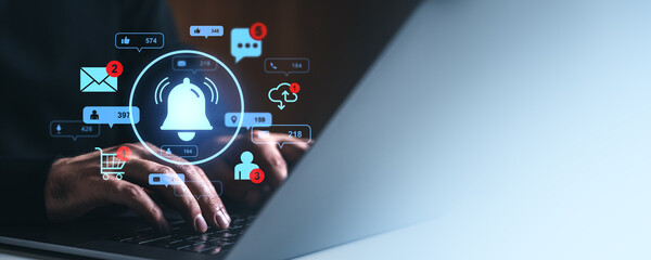 Hands typing on laptop with digital notification icons around on gradient background.