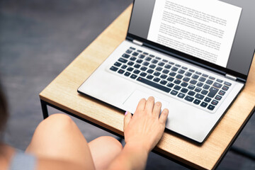 Writing blog. Content writer. Essay, letter, article, book or work text in laptop computer screen. Student in college or university. Woman proofreading school report. Journal or resume.