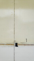 The door's bright yellow paint is starting to fade slowly.