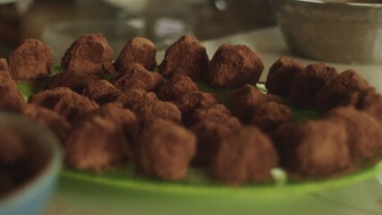 Close-up of homemade chocolate truffles on green plate