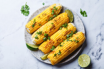 Grilled corn with cilantro, spices and butter.