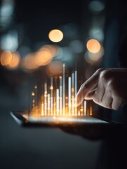 person using a tablet with a glowing bar chart hologram indicating data analysis or business analytics in a futuristic digital environment with blurred lights in the background