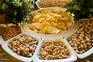 Delicious assortment of snacks featuring crispy chips and a variety of nuts