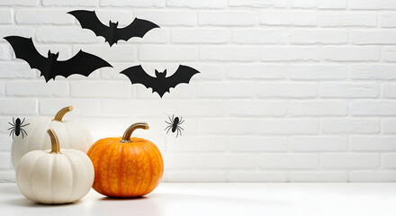 Halloween Decorations with Pumpkins and Bat Silhouettes on a White Brick Wall