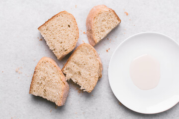 Overhead view of sliced homemade artisan bread with a plate of oil