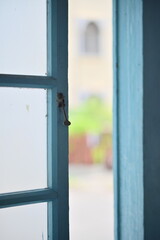 Close-up of a traditional Taiwanese wooden window latch, used to secure early wooden windows in old houses. The latch reflects historical craftsmanship and aged textures.