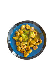 Fried tortellini with broccoli and garlic on a blue plate