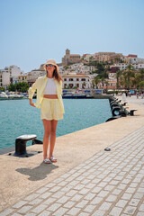 Stylish Young Woman in Yellow Outfit by the Seaside in Ibiza, Spain