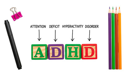 ADHD acronym blocks on a white house outline with colorful alphabet dice.