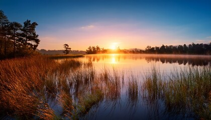 Obraz premium serene ripples on lake under glowing first light of sunrise