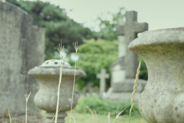 Crosses and gravestones in a cemetery on a cloudy day in London, UK