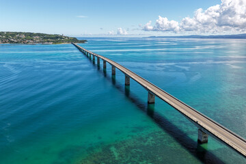 Fototapeta premium Aerial Drone View of Kouri Bridge (古宇利大橋) Stretching over Emerald Blue Sea, Okinawa, Japan