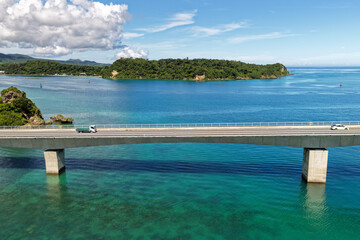 Close Aerial View of Kouri Bridge (古宇利大橋) with Cars over Turquoise Sea, Okinawa, Japan