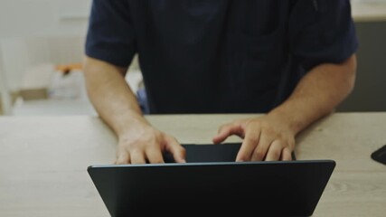 A black and abstract artwork, perfect for backgrounds or designs needing an element of mystery and sophistication. A Black male doctor is working on a laptop at his desk in a modern medical office - Powered by Adobe