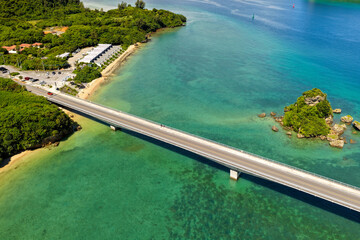 Side Aerial View of Kouri Bridge (古宇利大橋) over Coral Reef Lagoon, Okinawa, Japan