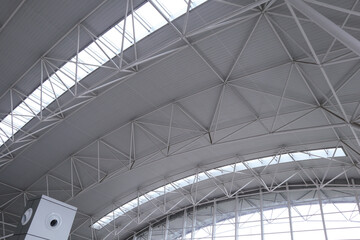 Modern geometric-shaped metal high ceiling with sunlight coming through