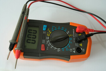 Digital multimeter placed on a table, ready for electrical measurements.