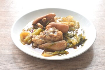 boiled braised salty pork leg and slice pickled cabbage in Chinese herb brown soup on plate