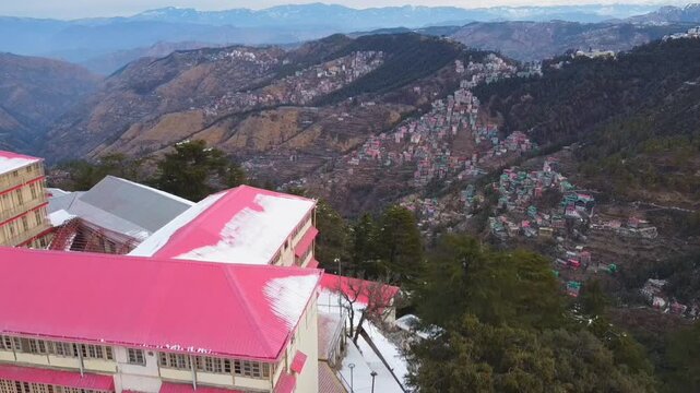 Shimla, Himachal Pradesh, India - February 1st 2025 - A Drone view of Shimla after snowfall offers a breathtaking panorama of the city and the dense pine & deodar forests, colonial-era architecture.