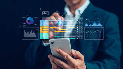 Businessman using smartphone with futuristic AI analytics dashboard, data visualization, and digital charts for business intelligence, big data, performance tracking, and modern technology solutions.