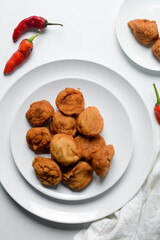 Overhead view of Akara on a white plate, top view of Brazilian acaraje fried beans cake on a plate