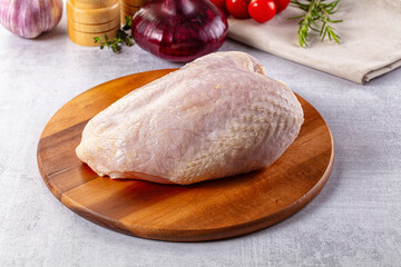 Raw chicken breast with bone and skin