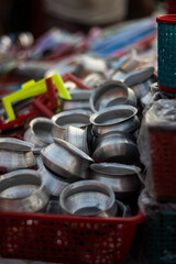 A collection of metal pots and pans displayed at a market stall