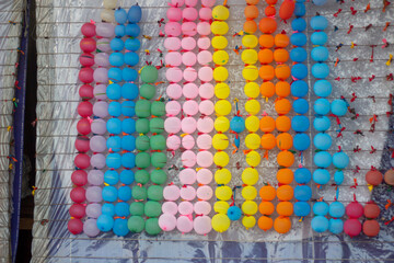Colorful plastic bottle caps arranged in vertical rows by color