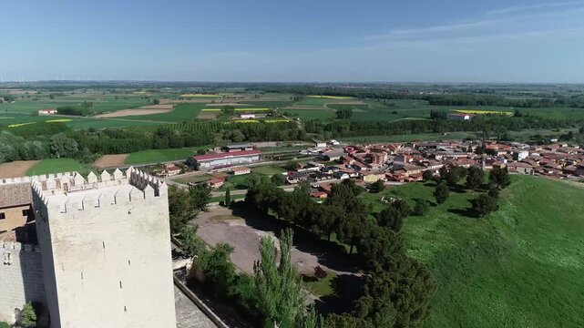 Aerial photo of Monzon de Campos Castle surrounded by green rural fields