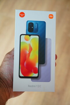 Hand Holding a Xiaomi Redmi 12C Smartphone Box