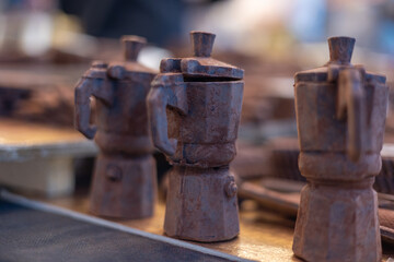 Chocolate moka pots arranged on a table, highlighting the rich italian tradition of coffee making while adding a delightful touch of sweetness and indulgence to the scene