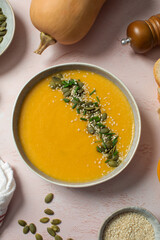 Plate with pumpkin soup puree, pumpkin and sesame seeds. Autumn menu. 