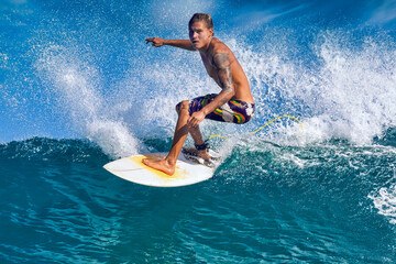 Male surfer on a blue wave at sunny day