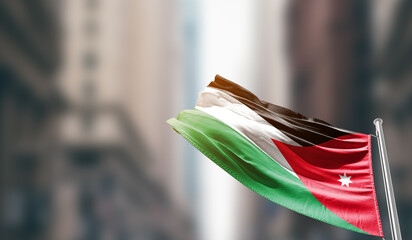 Jordan national flag waving on street. A beautiful with mast with blur buildings. Jordan national flag for independence day. © Muhammad Arif