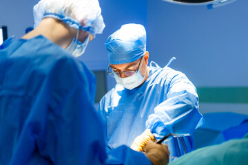 Surgeons in a sterile room. Medical professionals conduct a surgical procedure while maintaining strict hygiene in an operating room.
