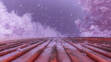 Infrared landscape of rust-colored pipes extending to a snowy, purplish twilight sky between frost-covered trees