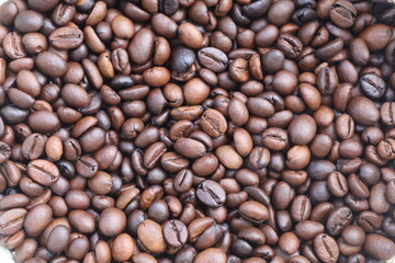 Photo of Big pile of fresh roasted coffee beans close up. Food photo for backdrops or recipes