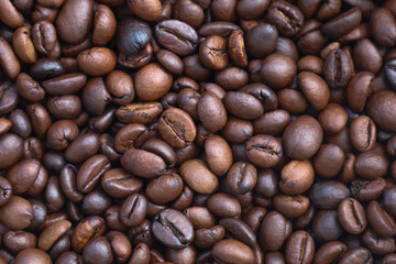 Photo of Big pile of fresh roasted coffee beans close up. Food photo for backdrops or recipes